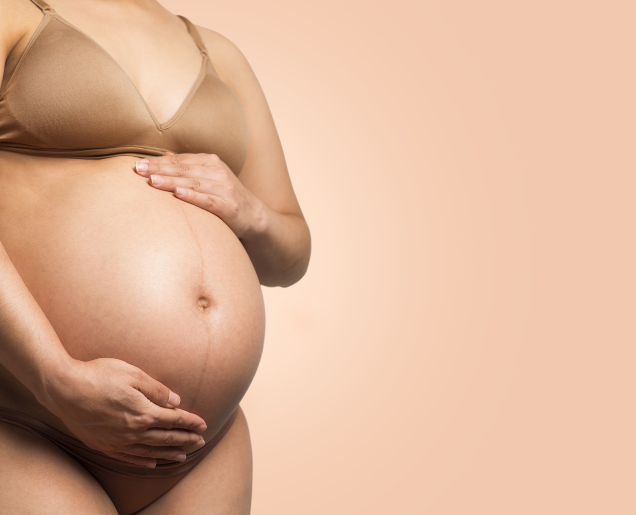 How does the woman’s body change in week 14 of pregnancy?