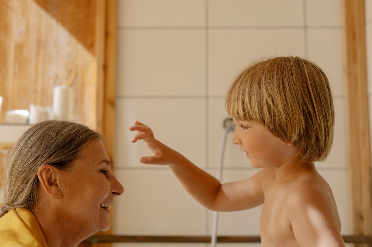 What is the recommended frequency for bathing children and adults?