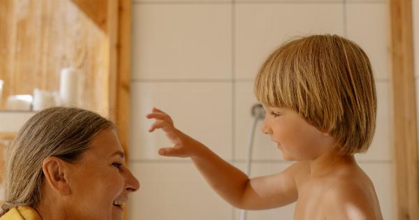 What is the recommended frequency for bathing children and adults?